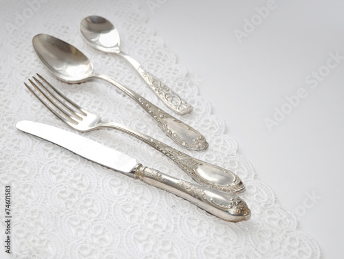 Vintage cutlery on white lace