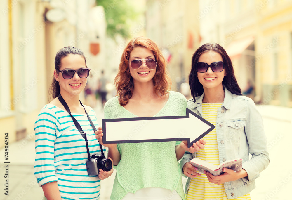 smiling teenage girls with white arrow outdoors smiling teenage girls with white arrow outdoors