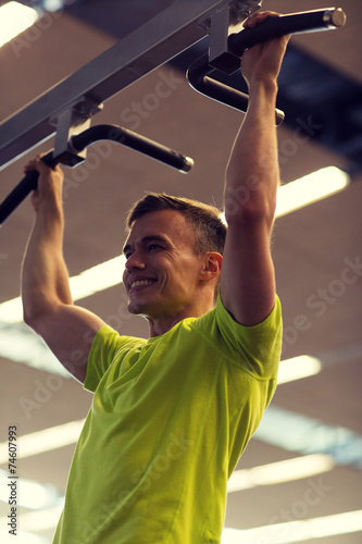 smiling man exercising in gym