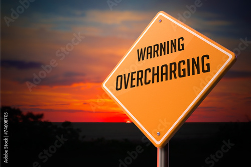 Overcharging on Warning Road Sign. photo