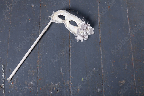 Carnival mask on dark wood background photo