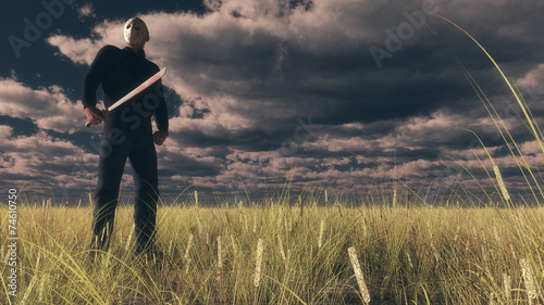 Tableau sur toile Serial killer with white mask holding bloody knife. Standing in