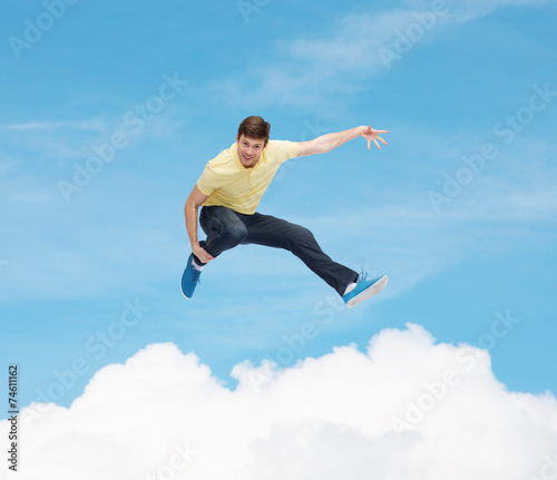 smiling young man jumping in air