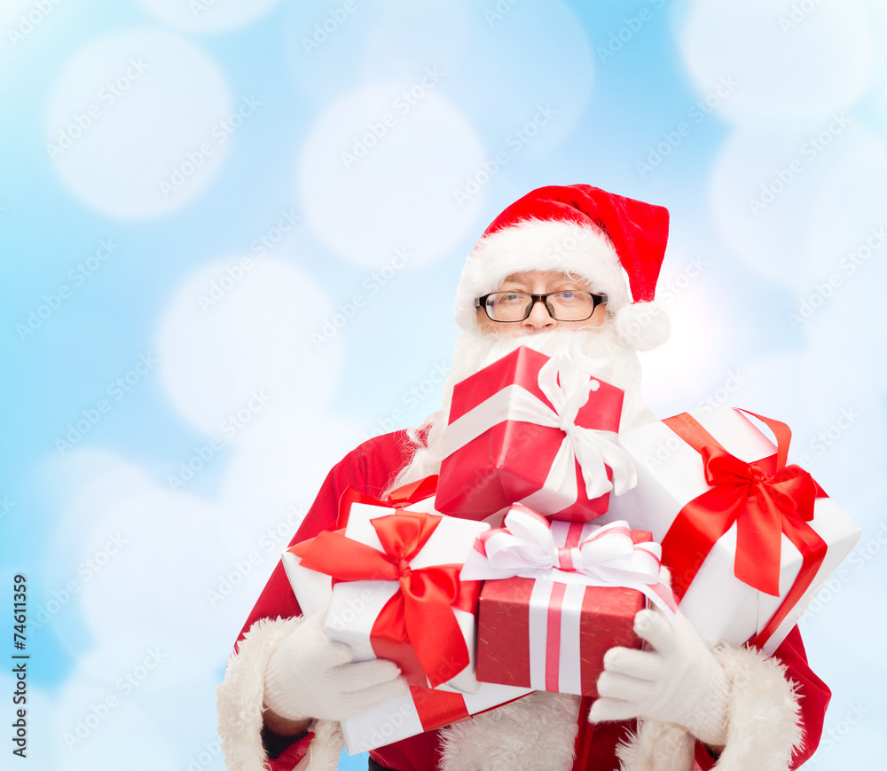 man in costume of santa claus with gift boxes man in costume of santa claus with gift boxes
