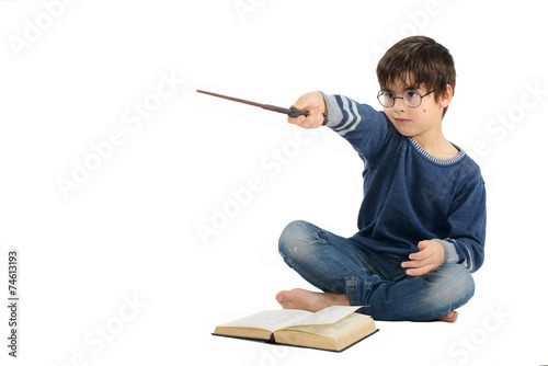 Little cute boy is reading a book and imagining himself a hero