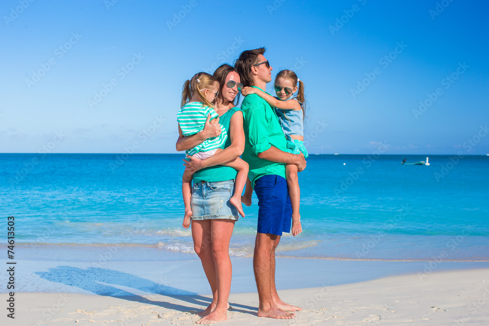 Young happy family with two kids on summer vacation