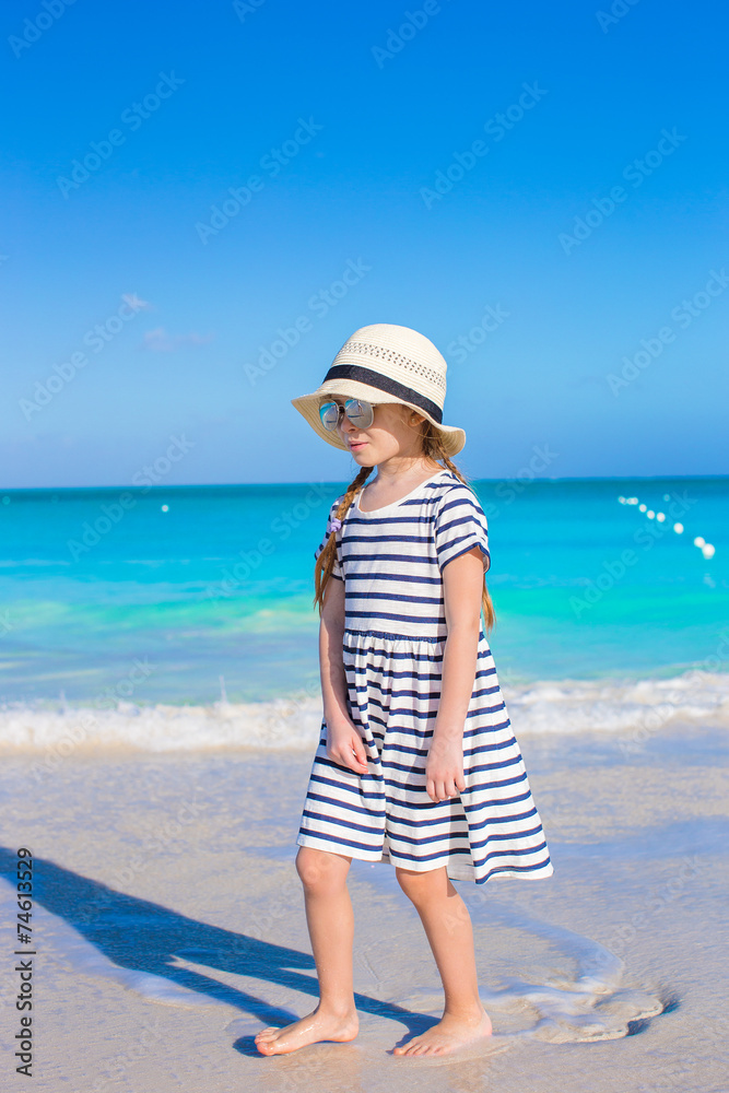 Adorable little girl during beach vacation have fun