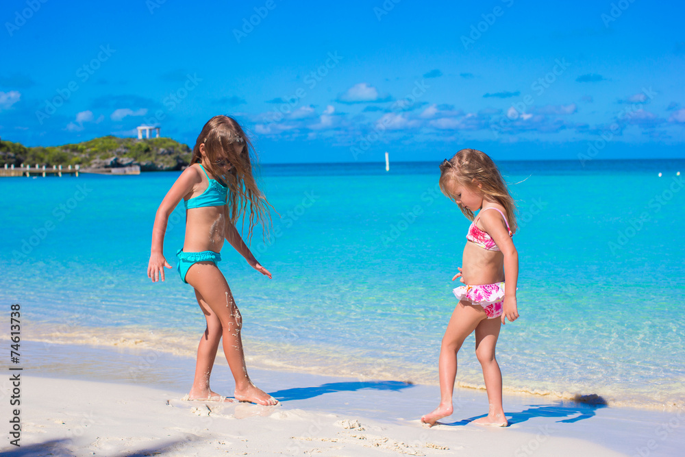 Little girls enjoy their summer vacation on the beach