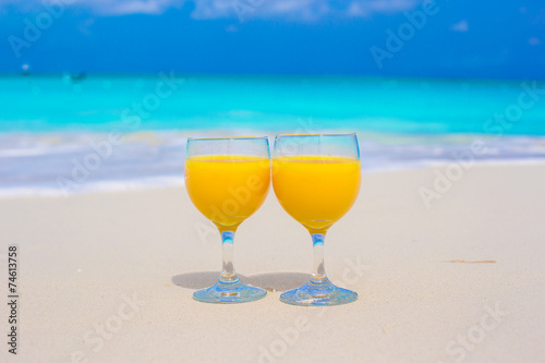 Closeup of two glasses on tropical white beach