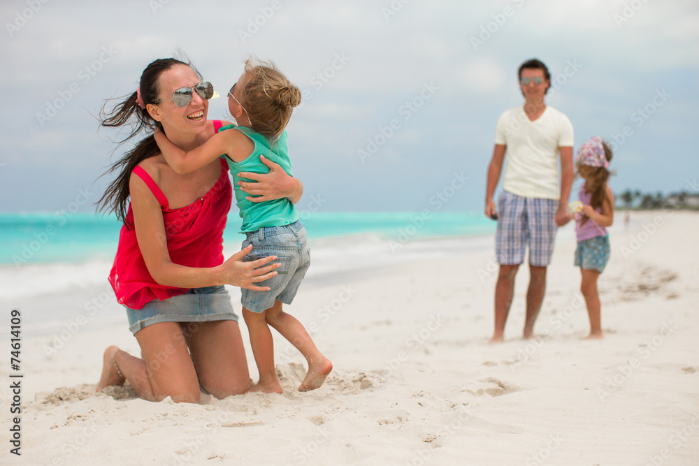 Family of four with two kids during beach summer vacation