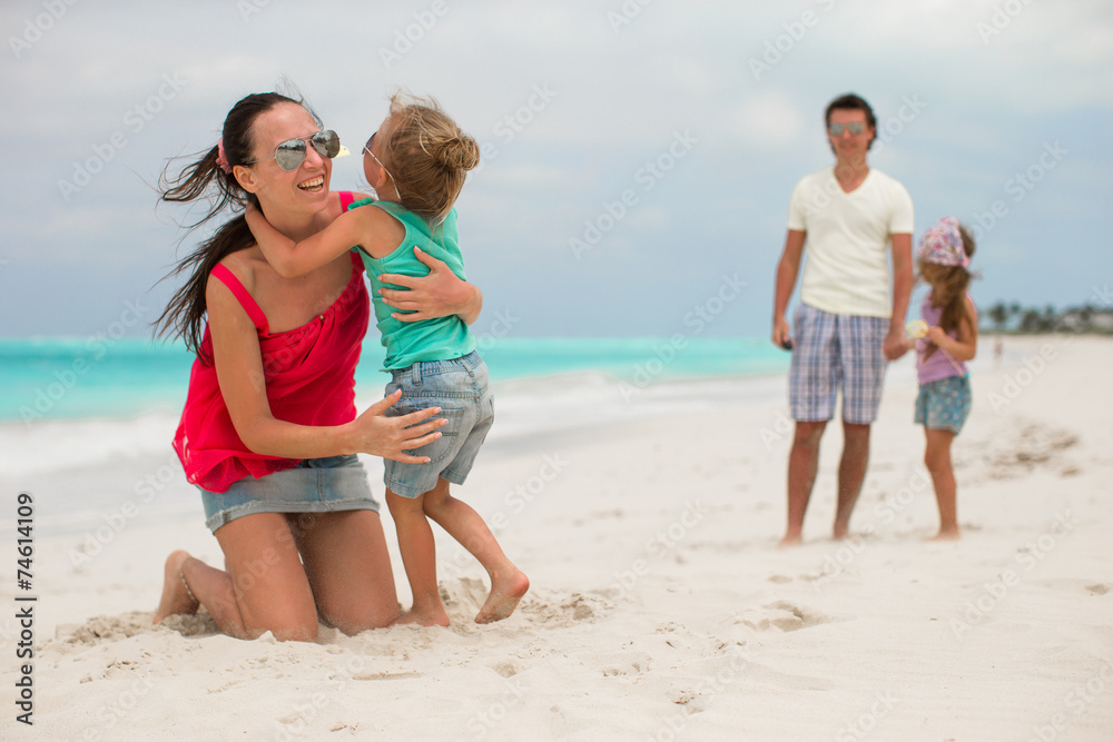 Family of four with two kids during beach summer vacation Family of four with two kids during beach summer vacation