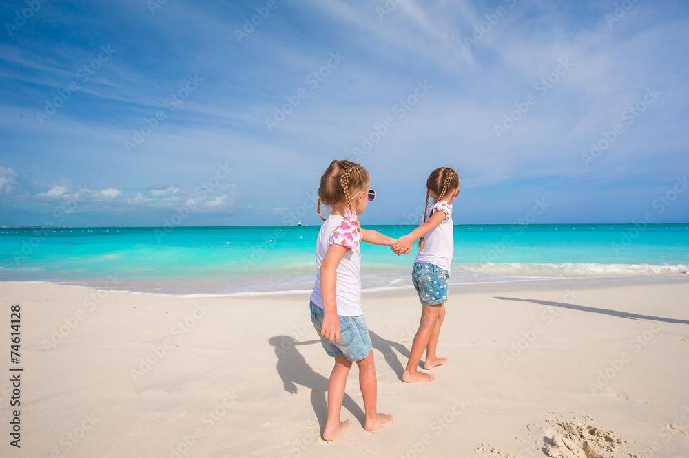 Little girls having fun during tropical beach vacation Little girls having fun during tropical beach vacation