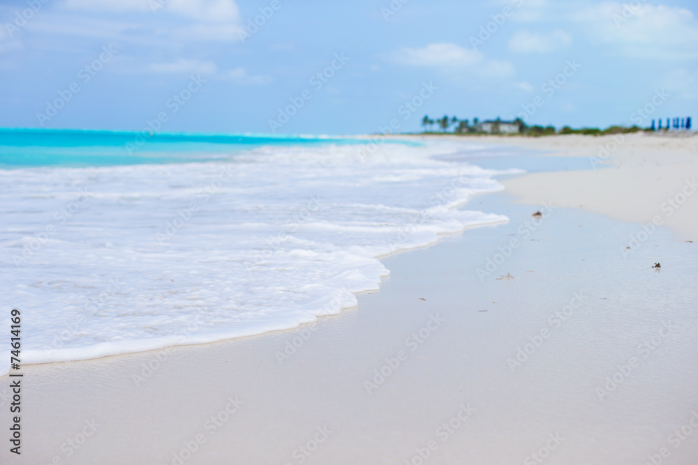 White sandy beach with turquoise water at perfect island