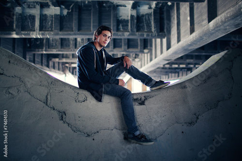 Portrait of Young Man Sitting Ledge