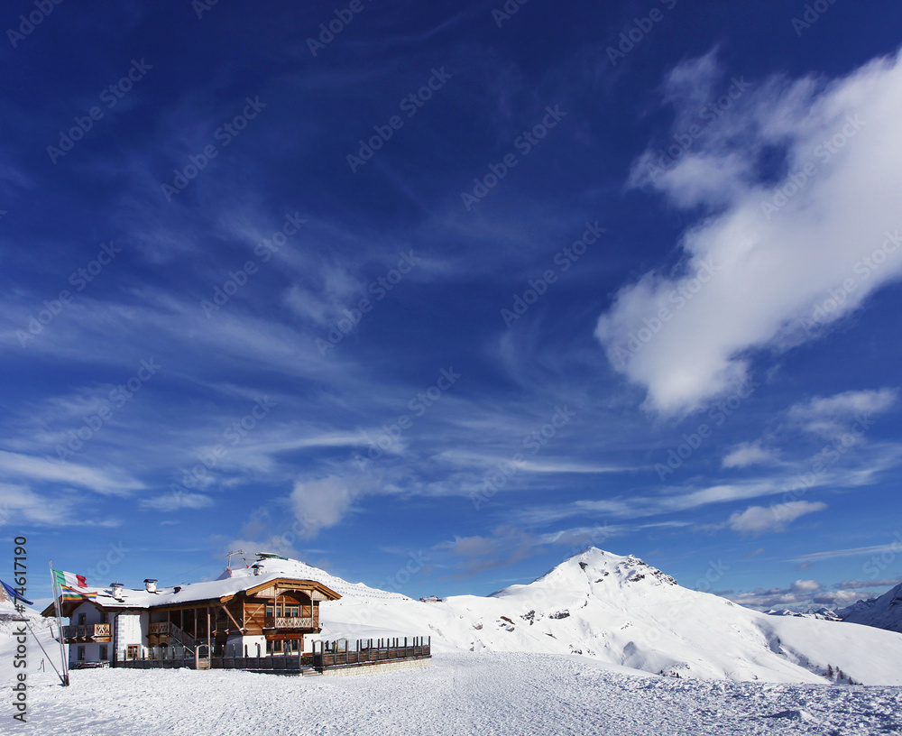 Beautiful winter mountain landscape and cottage in Trentino