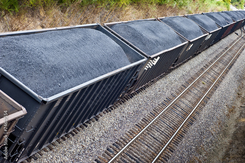 Photo Line of Coal Freight Cars On Train Track