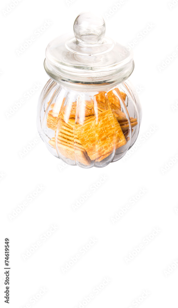 Sugar crackers or biscuits in a cookie jar over white background Sugar crackers or biscuits in a cookie jar over white background