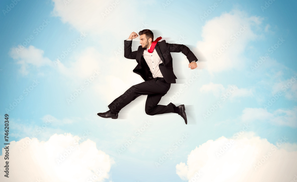 Business person jumping over clouds in the sky Business person jumping over clouds in the sky