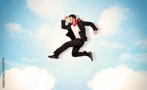 Wallpaper Mural Business person jumping over clouds in the sky Torontodigital.ca