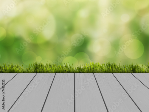 Wood floor terrace with green glass and natural bokeh background