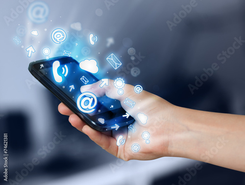 Wallpaper Mural Business man holding smart phone with media icons Torontodigital.ca