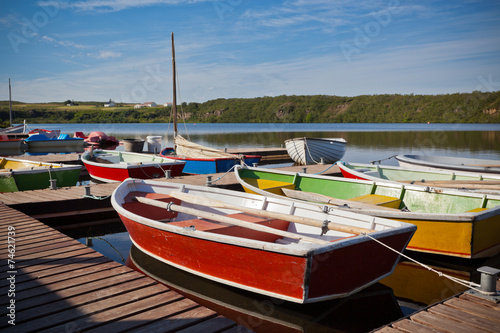 Wallpaper Mural Floating Color Wooden Boats with Paddles in a Lake Torontodigital.ca