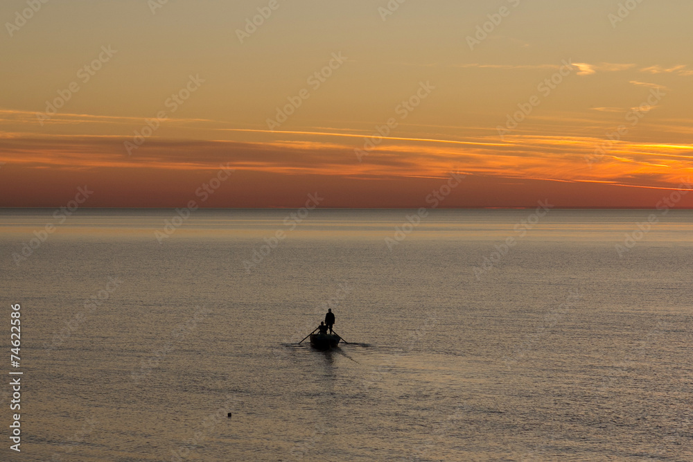 Fototapeta premium Silhouette of the man in a boat