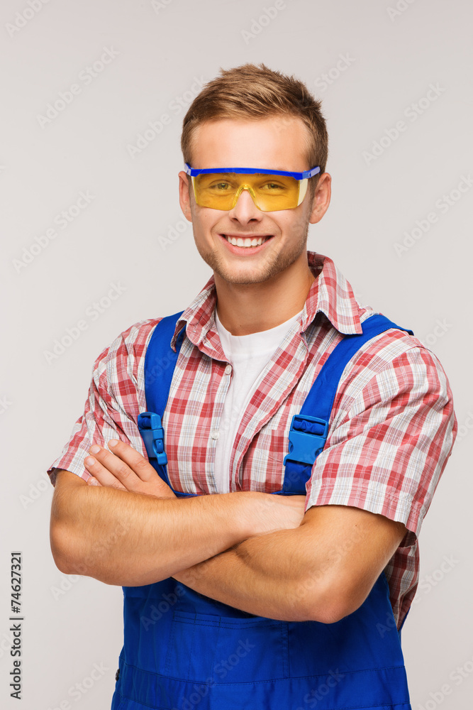 Young smiling repairman in eyewear Young smiling repairman in eyewear