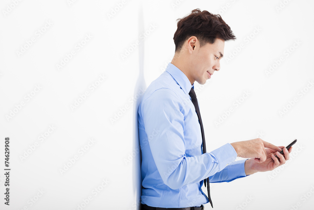 businessman touching smart phone in office businessman touching smart phone in office