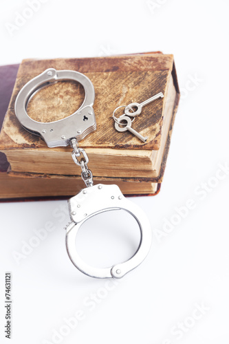 handcuffs and book on law 