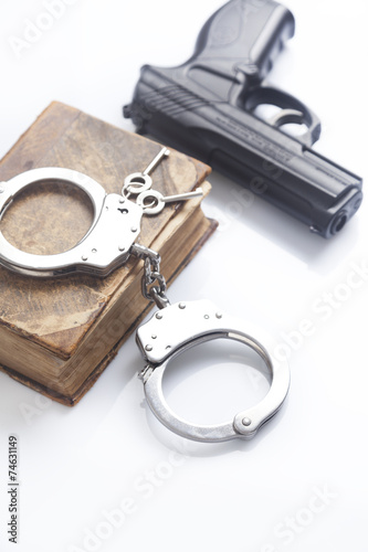 handcuffs and book on law and gun