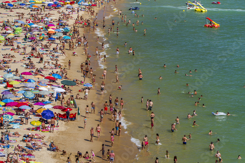 Broad view of a crowded beach on Portimao, Portugal.
