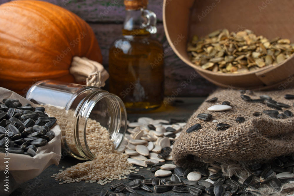 Sunflower and pumpkin seeds on the wooden table