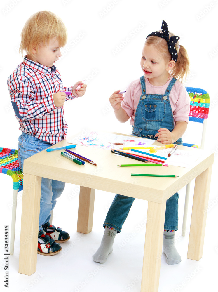 Girl and boy sitting at the table draw. Girl and boy sitting at the table draw.