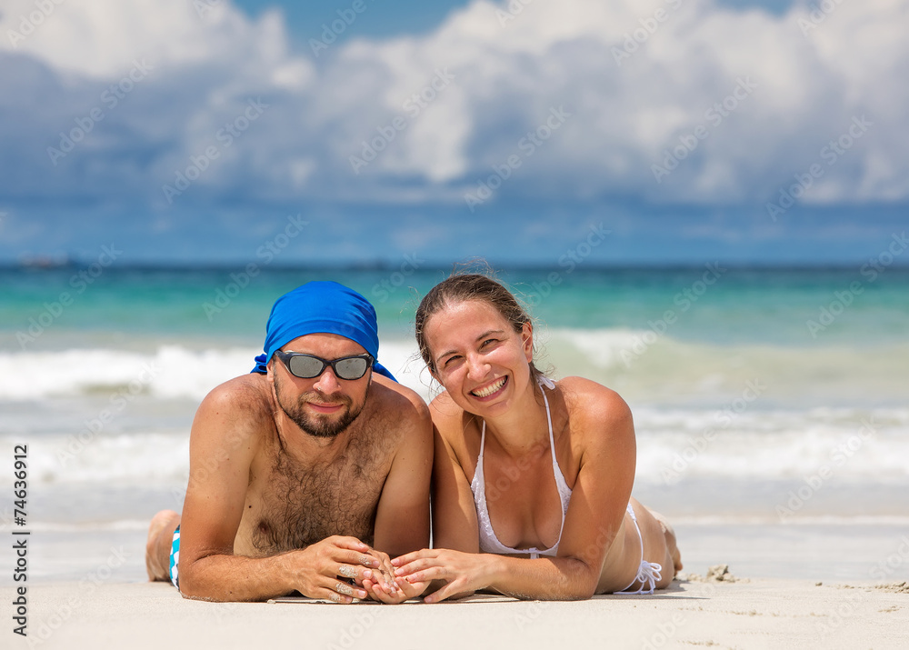 Man and woman have fun at the beach of island in Indian ocean