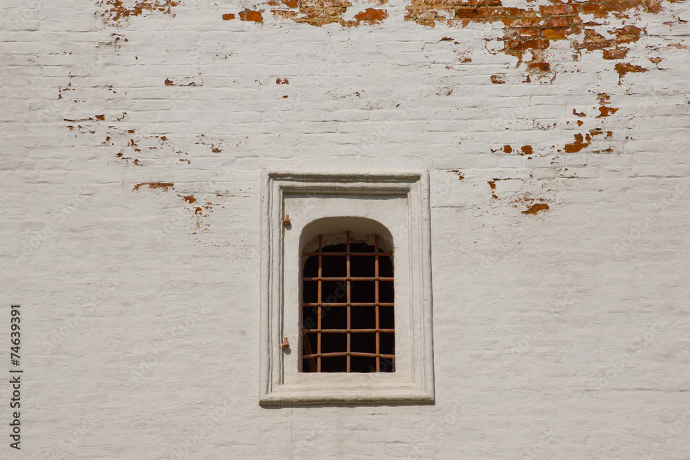 Fototapeta premium window with iron bars on brick wall