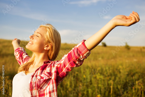 Happy girl in the rays of sun photo