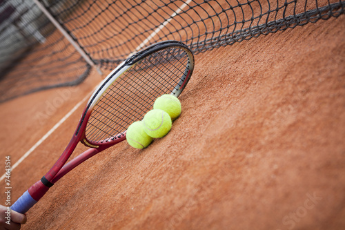  tennis racquet and balls on the clay tennis court  © pawel70