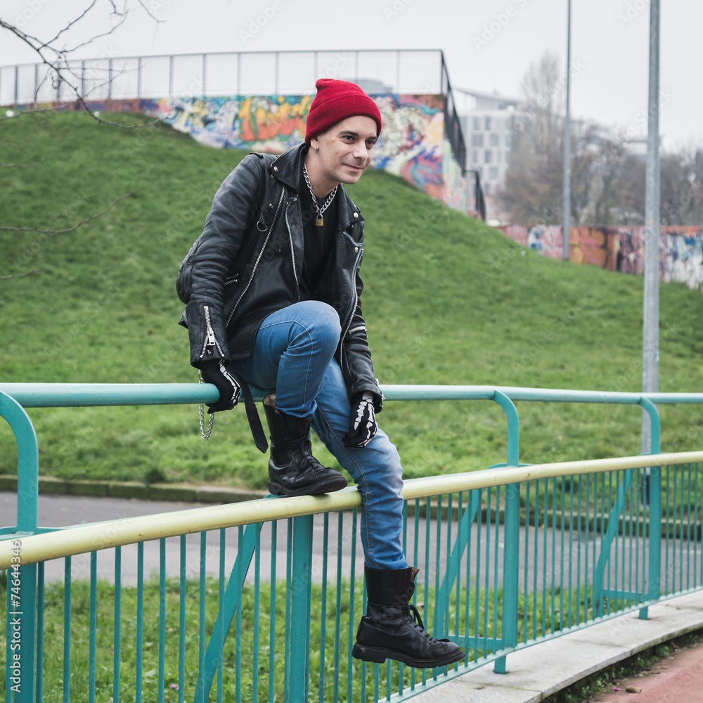 Punk guy posing in a city park