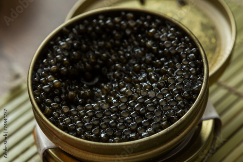Black caviar in small round metal tin