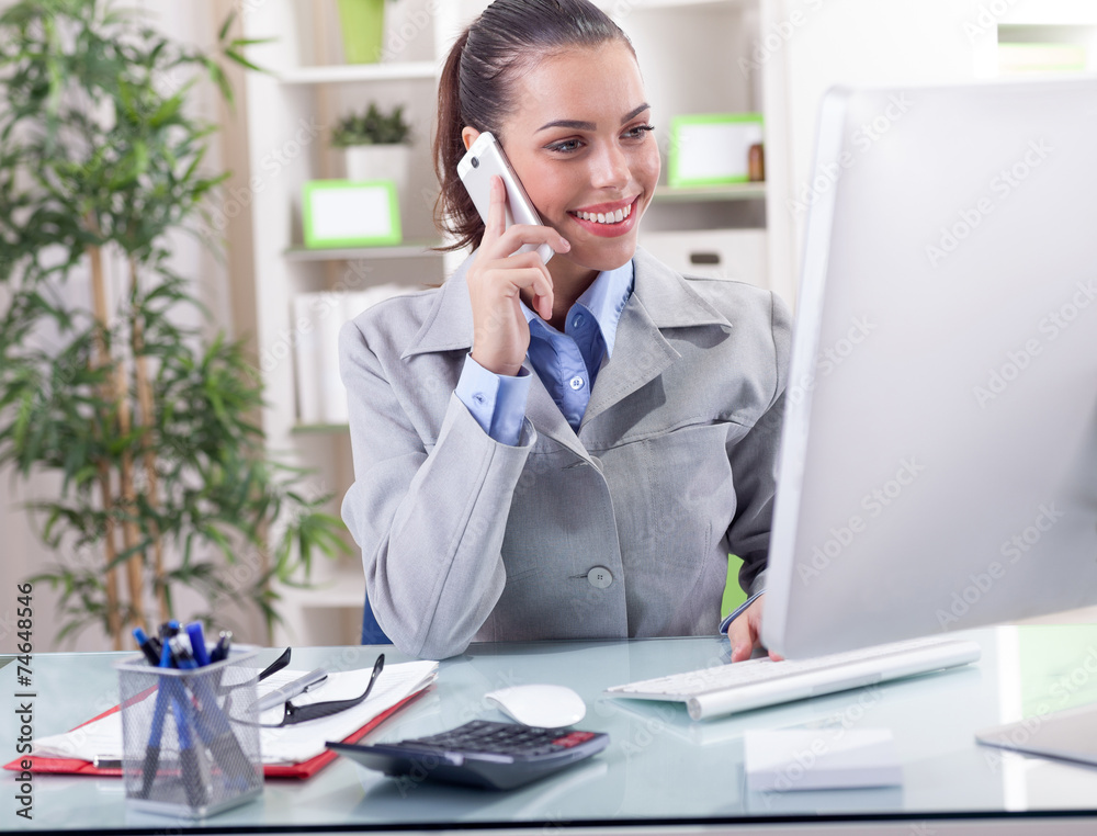 business concept - businesswoman talking on the phone in office