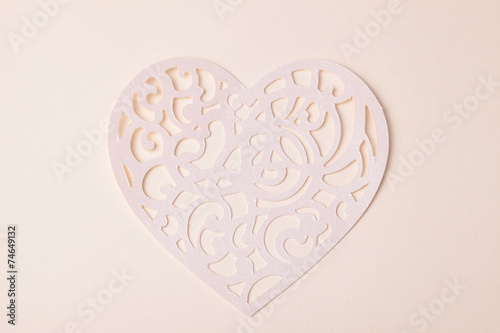 carving heart cutted from paper on the paper background