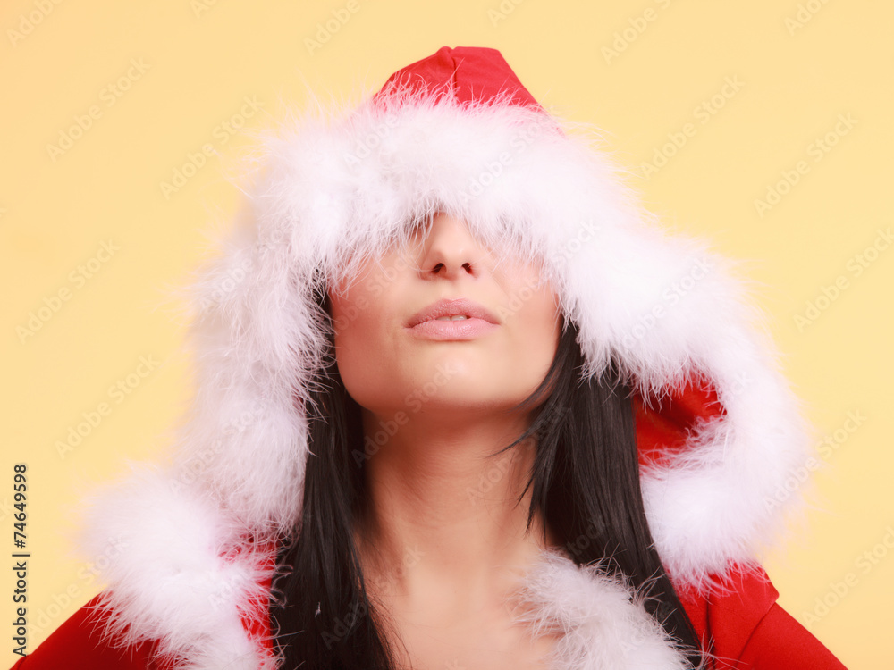 woman wearing santa claus costume covering her eyes on yellow woman wearing santa claus costume covering her eyes on yellow