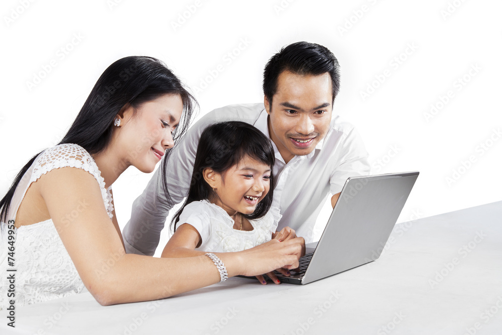 Cheerful family with laptop in studio