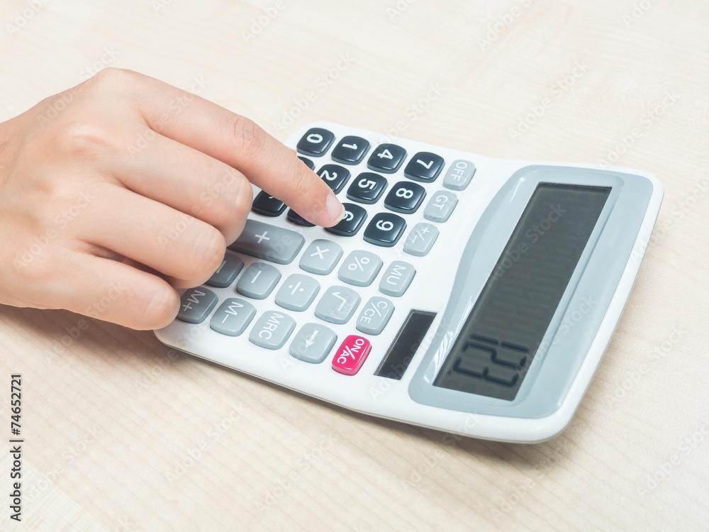 Hand on calculator Hand on calculator