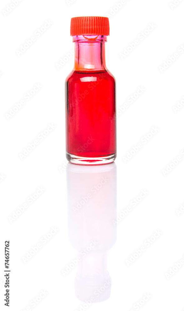 Liquid light red food color additive over white background Liquid light red food color additive over white background