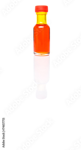 Liquid orange food color additive over white background photo