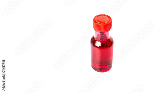 Liquid light red food color additive over white background