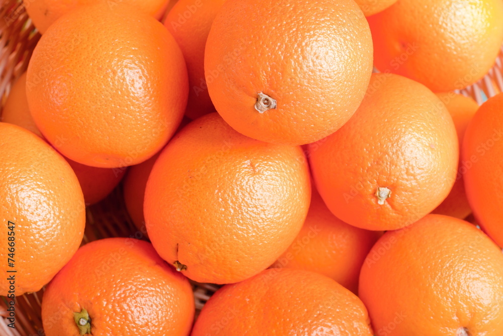 Beautiful ripe oranges on the table and a yellow orange backgrou Beautiful ripe oranges on the table and a yellow orange backgrou