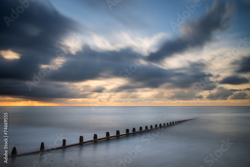 Fototapeta Naklejka Na Ścianę i Meble -  Beautiful long exposure vibrant concept image of ocean at sunset